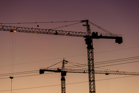 Construction two crane building the evening.の写真素材