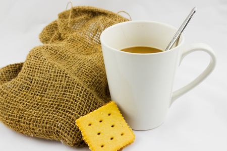 Coffee cups white and hemp sackcloth on white badkground.の写真素材