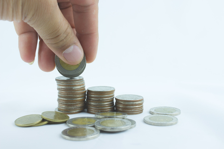 Close-up Of Businessman Hand Count and Put Money Coins To Stack Of Coinsの写真素材