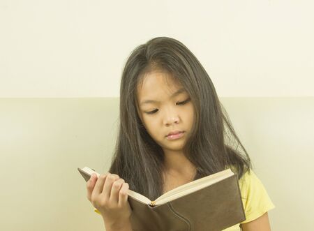 Children holding books in hand and reading it.の写真素材