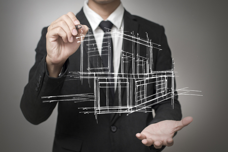 Businessman drawing a model of the houseの写真素材