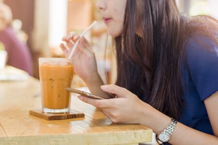 Business woman indoor with coffee and smart phone