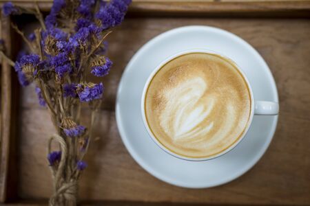 hot latte art on wood table backgroundの写真素材