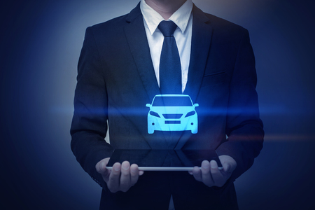Close up of businessman holding car iconの写真素材
