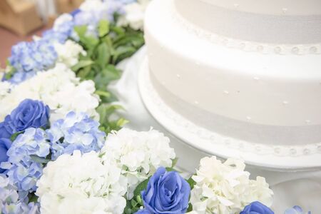 White wedding cake with flowerの写真素材