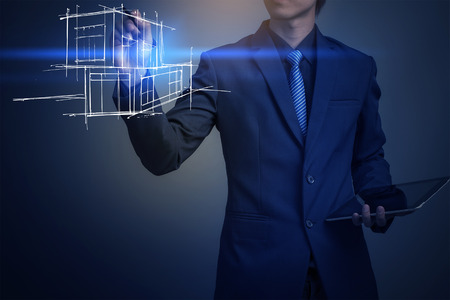 Businessman drawing a model of the houseの写真素材