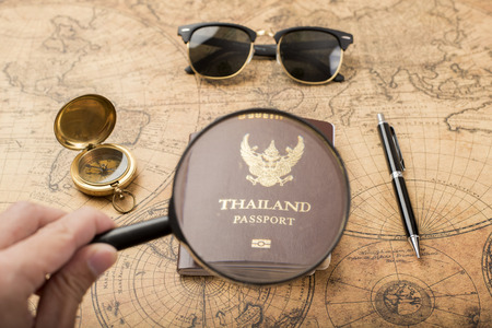 Planning travel concept, Thailand passport on old mapの写真素材