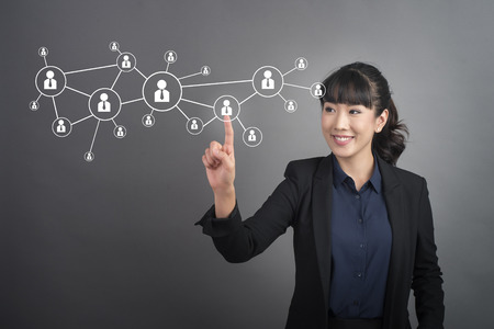 Beautiful Business Woman touching human connect  sign on virtual screenの写真素材