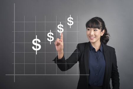 Beautiful Business Woman touching finance money bottom sign on virtual screenの写真素材