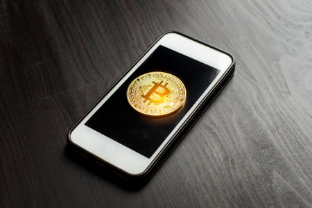 Bitcoin gold on the Smartphone. new cryptocurrency conceptの写真素材