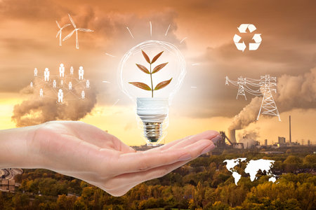 save earth concept, human hand holding light bulb on Industrial  backgroundの写真素材