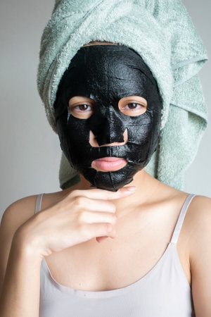 Beautiful woman with Black  facial mask, Lifestyle conceptの写真素材