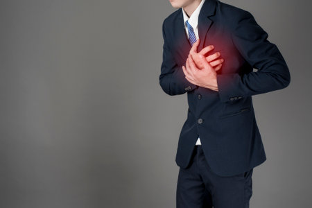 Business man is heart attack  ,grey background in studio