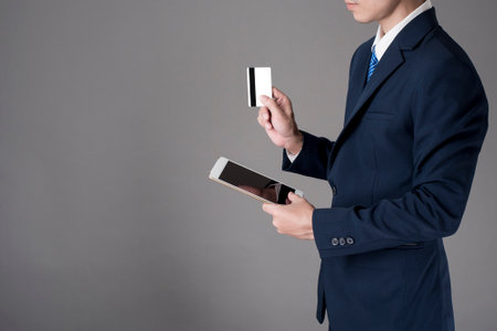 Business man is holding  credit card and tablet , Shopping online conceptの写真素材