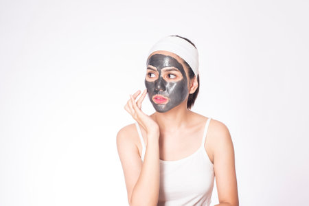 beautiful woman masking her face on white backgroundの写真素材
