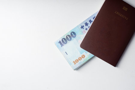 Passport and 1000 New Taiwan Dollar bill on white backgroundの写真素材