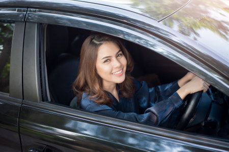 Beautiful woman is driving her carの写真素材