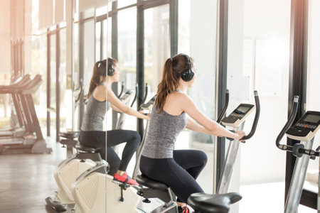 Pretty young sport woman is exercise on bicycle in gym, Healthy lifestyle
