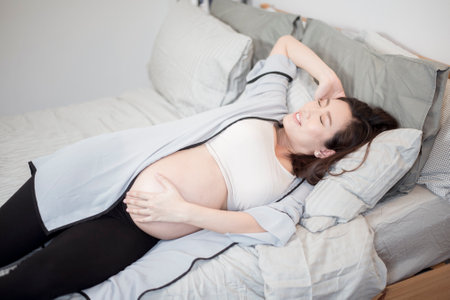 Beautiful asian pregnant woman is wake upの写真素材