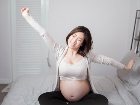 Beautiful asian pregnant woman is wake upの写真素材