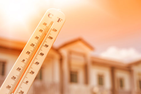 Thermometer shows the temperature is heat in the skyの写真素材