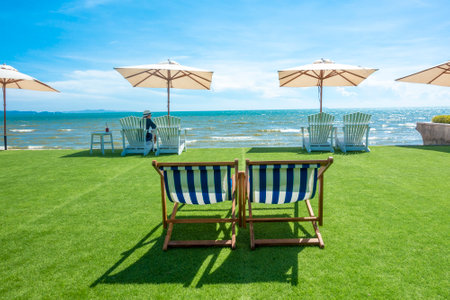 lounge chairs with sun umbrella on a beachの写真素材
