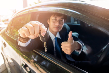 Business man  is holding key car in the car