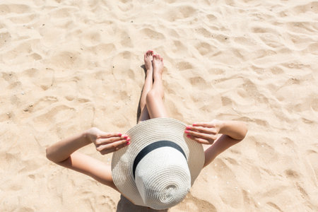 Beautiful woman is sitting on beachの写真素材