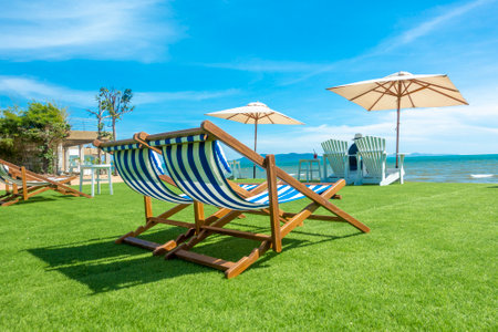 lounge chairs with sun umbrella on a beachの写真素材