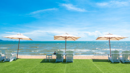 lounge chairs with sun umbrella on a beachの写真素材