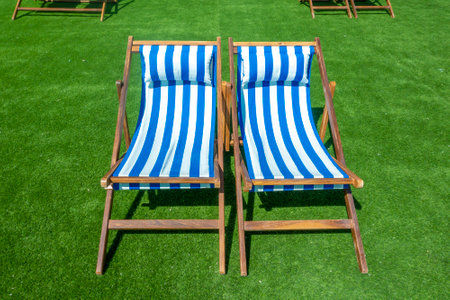 lounge chairs with sun umbrella on a beachの写真素材