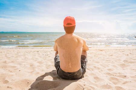 A Man is sitting on beach, summer conceptの写真素材
