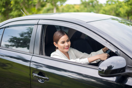 Beautiful woman is driving her carの写真素材