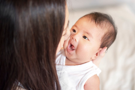 Adorable New born baby  resting in mothers arms.の写真素材