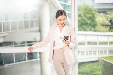 Beautiful business woman is using smart phone for businessの写真素材