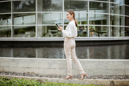 Beautiful business woman is working outside officeの写真素材