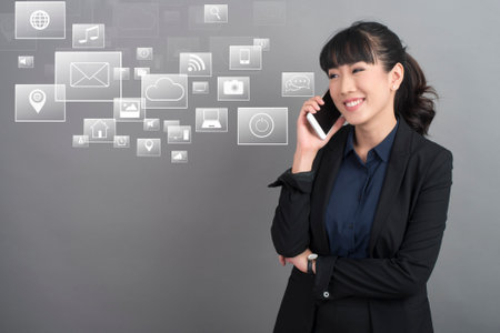 Beautiful asian women using smart phone with multimedia icon ,technology conceptの写真素材