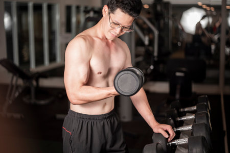 Asian man is working out  in fitness gymの写真素材