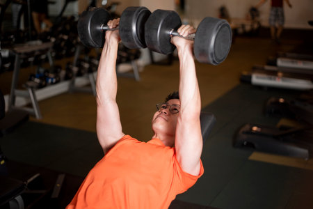 Asian man is working out  in fitness gymの写真素材