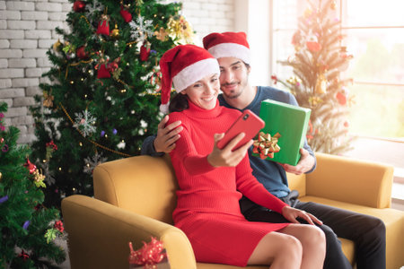 Attractive Caucasian couple of love are  celebrating Christmas in homeの写真素材