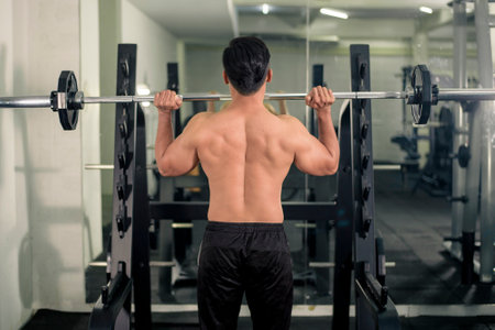 Bodybuilder man with big muscular  back in the gymの写真素材