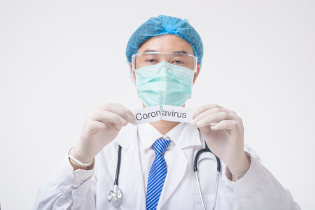 Doctor is holding Coronavirus card on white backgroundの写真素材