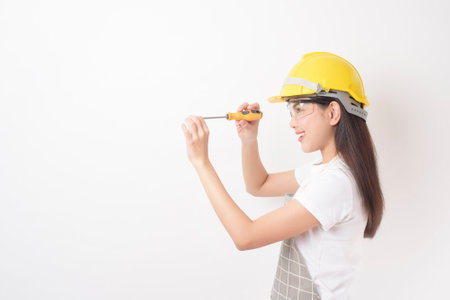 woman technician portrait on white backgroundの写真素材