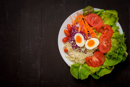 Vegetables Salad on black  wooden  backgroundの写真素材