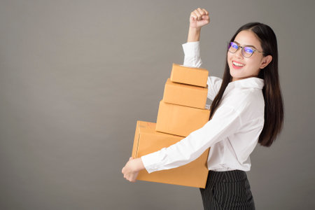 Beautiful happiness  woman with box portrait  in studioの写真素材