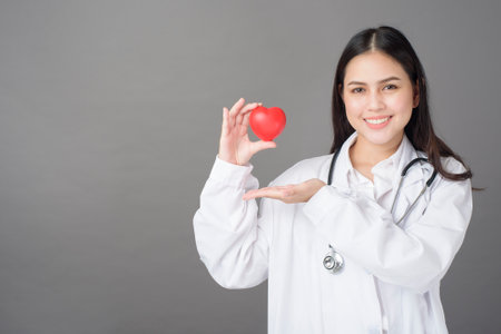 woman doctor is holding red heartの写真素材