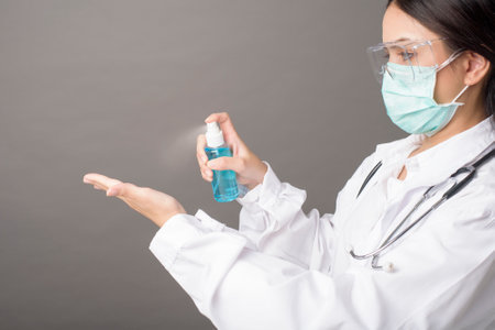 woman doctor is using hand sanitizer