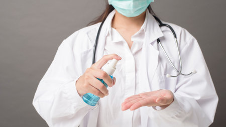 woman doctor is using hand sanitizerの写真素材