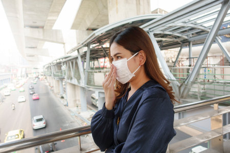 Beautiful woman wearing anti dust mask protect air pollution and pm 2.5 on street cityの写真素材