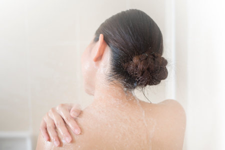 Happy  beautiful woman is taking a showerの写真素材